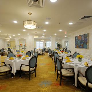 An elegantly decorated dining room with neatly arranged tables and chairs.