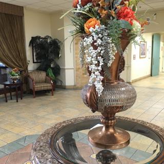 A beautifully arranged floral centerpiece in a welcoming lobby space.