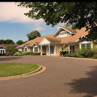 A suburban home with a curved driveway and lush landscaping.