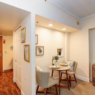 Cozy dining nook in a well-decorated apartment with wood flooring and ambient lighting.