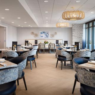 Modern restaurant interior with elegant seating and stylish chandeliers.