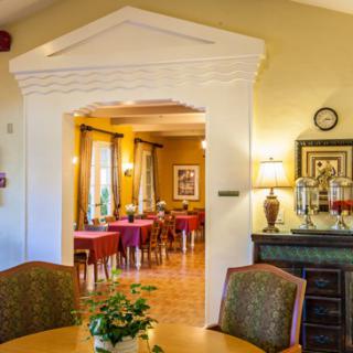 A warmly lit dining room with elegant decor and furnishings.