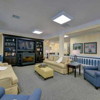 A cozy living room with comfortable seating and a large television.