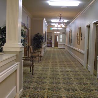 A well-lit hallway featuring decorative elements and comfortable seating.