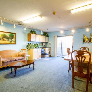 A cozy living and dining area with classic furniture and decorative elements.
