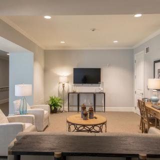 A modern living room with a sofa, coffee table, and television.