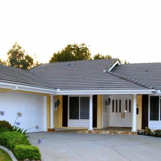 A suburban house with a well-maintained front yard and driveway.