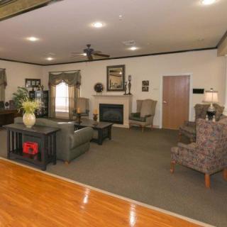 A spacious living room with comfortable seating and a fireplace.