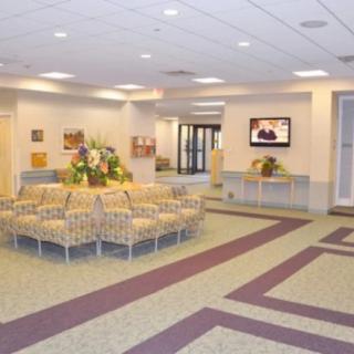 A spacious waiting area with seating and a television.