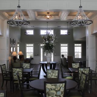 A beautifully decorated dining area with elegant chandeliers and stylish furniture.