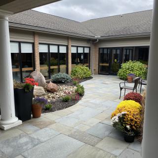 A beautifully landscaped courtyard with a variety of plants and outdoor seating.