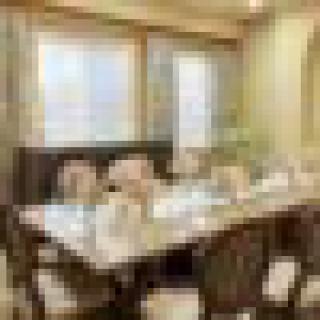 An elegantly decorated dining room with a large table and multiple chairs.