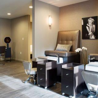 A modern spa salon with a pedicure station and stylish interior design.