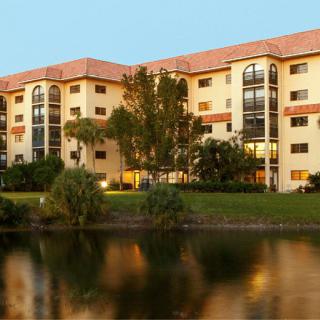 A lakeside apartment building reflecting the evening sunlight.