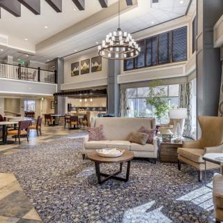 A modern and spacious hotel lobby with elegant furniture and abundant natural light.