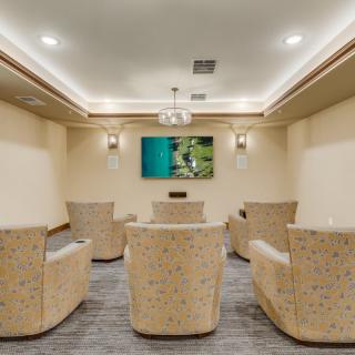 A cozy home theater with plush seating and ambient lighting.