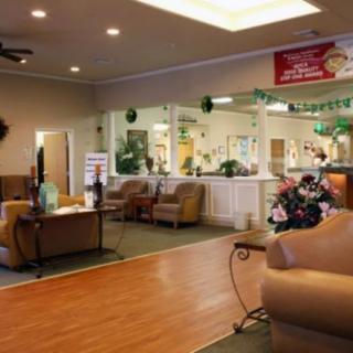 A cozy lobby area featuring comfortable seating and a reception desk, adorned with festive decorations.