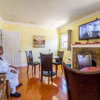 A person sitting in a cozy living room watching television.