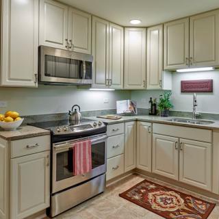 A modern kitchen with stainless steel appliances and light-colored cabinetry.