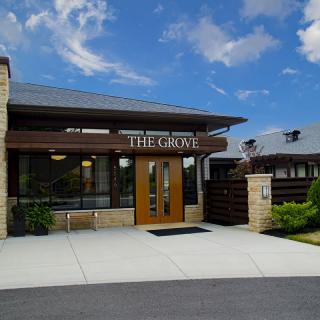 The exterior of 'The Grove' restaurant on a sunny day.