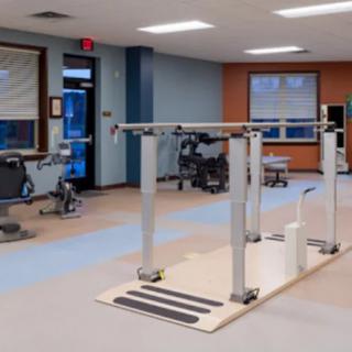 An indoor physical therapy and rehabilitation room equipped with exercise equipment.