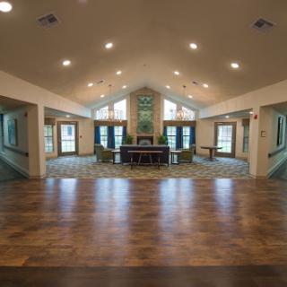 A spacious and well-lit interior room with modern decor and wooden flooring.