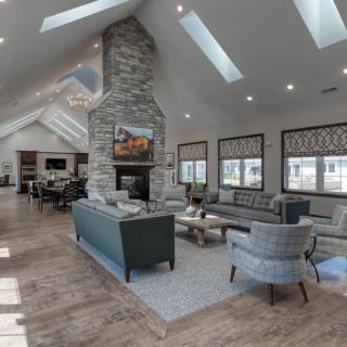 Spacious and modern living room with a central fireplace and ample natural light.