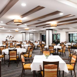 A modern and elegantly designed restaurant dining area with neatly arranged tables and chairs.