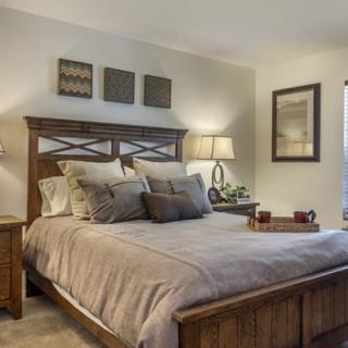 A warm and inviting bedroom with stylish decor and comfortable bedding.