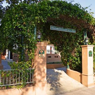 A charming entrance adorned with greenery leading to a building.