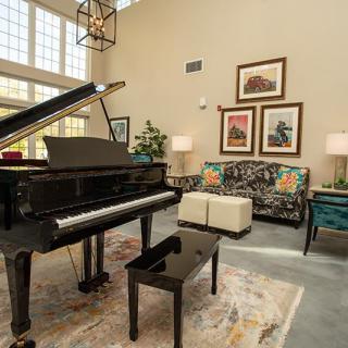 A beautifully designed living room featuring a grand piano and elegant furnishings.