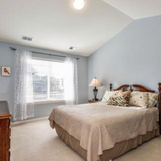 A cozy bedroom with a large window letting in natural light.