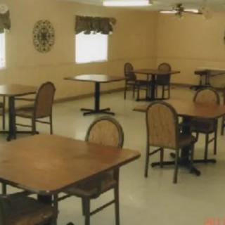 An empty dining room with tables and chairs neatly arranged.