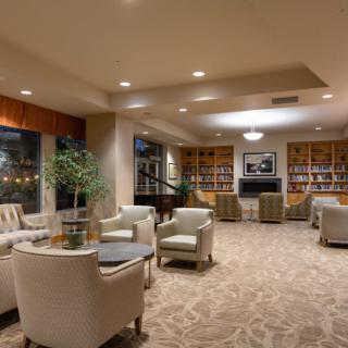 A cozy lounge area with comfortable seating and bookshelves.