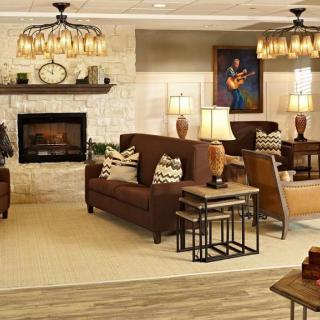 A cozy living room with comfortable sofas, a fireplace, and warm lighting.
