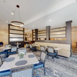 A modern dining area with neatly arranged tables and chairs, featuring stylish interior decor.