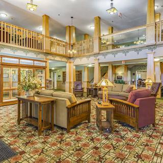 A well-furnished hotel lobby with comfortable seating and wooden accents.