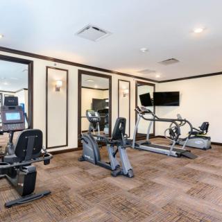 A modern gym with various exercise machines and equipment.