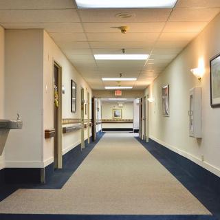 An empty hospital corridor with bright lighting and clean design.