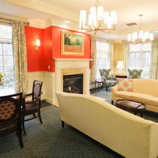A cozy living room setup featuring a soft sofa, chairs, and a fireplace.