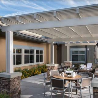A modern patio with a pergola and outdoor seating area.