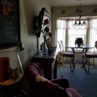 A cozy living and dining area with elegant furnishings and large windows allowing natural light.