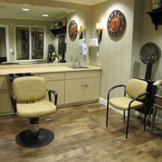 A cozy hair salon interior with styling chairs and mirrors.