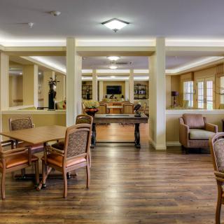 A cozy interior lounge area with comfortable seating and tables.