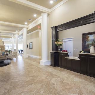 A spacious and elegantly designed hotel lobby with a welcoming reception desk.