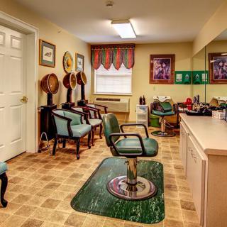 A vintage-style hair salon interior with barber chairs and mirrors.