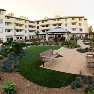 A well-landscaped exterior view of a residential building with a central garden and pathways.