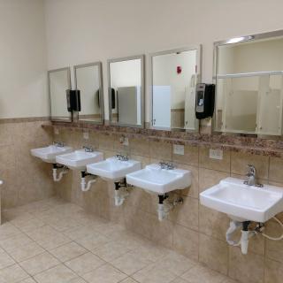 A clean public restroom with a row of sinks and mirrors.