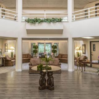 A spacious and elegantly decorated lobby with comfortable seating areas and greenery.