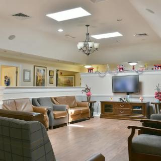 A cozy living room with comfortable seating, a television, and elegant decor.